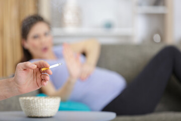 Obraz na płótnie Canvas pregnant woman disgust on cigarette