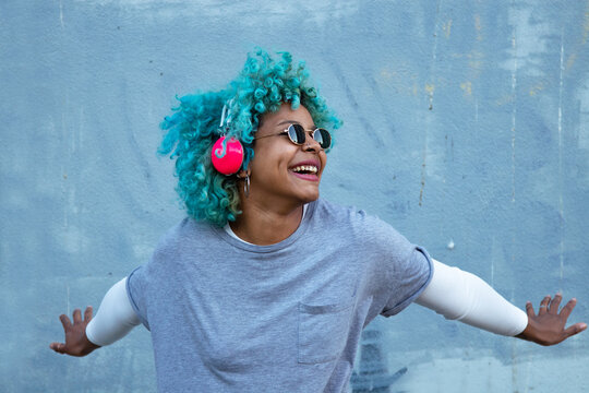 Black Afro American Woman With Headphones On The Street Smiling Happy