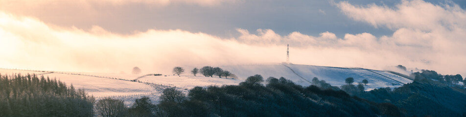 Panoramic winter view of beautiful Welsh landscape during the winter season. clouds and mist low down. south wales uk