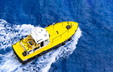 Cruise ship guide boat sailing the blue waters of the ocean in the Bahamas
