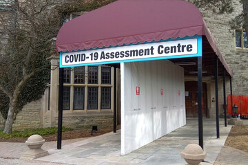 Toronto, Ontario, Canada - 03/16/2021: Building used as COVID - 19 assessment Centre.  The outdoor tent was set up for people to the lineup.