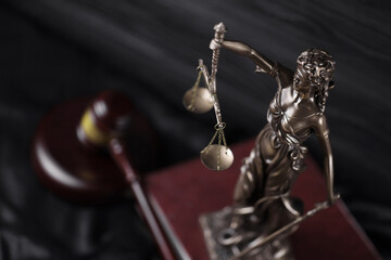 The Statue of Justice - lady justice or justitia the Roman goddess of Justice. Statue on brown book...