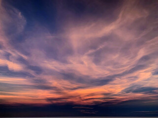 Naklejka na ściany i meble Fantastic sunset clouds in night sky. Purple magical cloudscape. Incredible heaven spectacle.