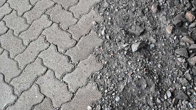 Unfertige Pflasterarbeiten - fertig verlegt vom Landschaftsg&auml;rtner und im rohen Zustand als Schotter Hintergrund