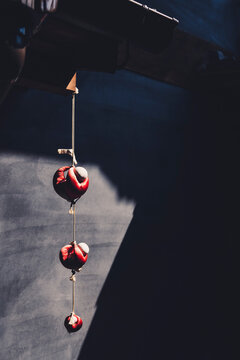 Close-up Of Red Objects Hanging Against Wall