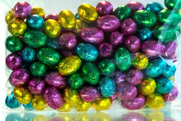 Fototapeta na wymiar Colorful chocolate easter eggs. A pile of colorful chocolate Easter Eggs.