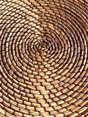 Fototapeta premium Amazing well patterned of brown rattan placemat, circle brown background, texture
