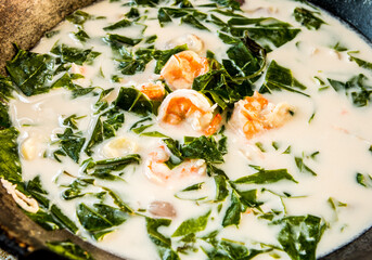Cooking Melindjo leaves in coconut milk soup with prawn, Thai southern famous food