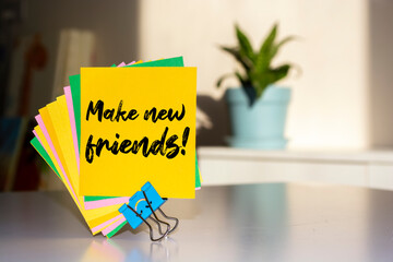 The words Make new friends write on Sticky Notes.