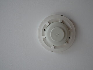 smoke detector fire alarm head on the ceiling in office.
