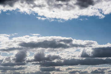 Blue sky, clouds, and the glow of the sun