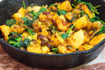 Saag Aloo, Indian style spinach and potatoes in cast iron pan