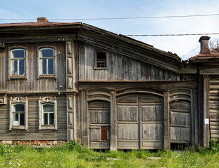Old russian traditional wooden house with the carved facade. Rickety house. Village of Visim, Sverdlovsk oblast, region of Ural, Russia.