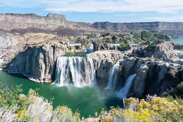 Scenic elevated view of Shoshone Falls waterfall on the Snake River under blue sky