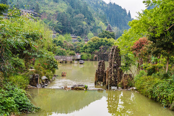 Fototapeta na wymiar Wind and Rain Bridge and Waterwheel in Dong Village, Zhaoxing, Guizhou, China