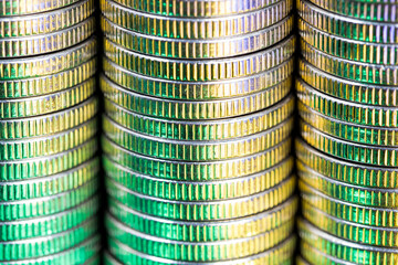 coins of silver color illuminated with yellow green color