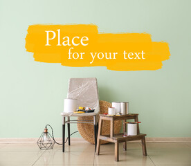 Cans of paints and tools with furniture near color wall with space for text