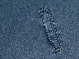 Bright blue denim fabric with a pocket and a beautiful texture.