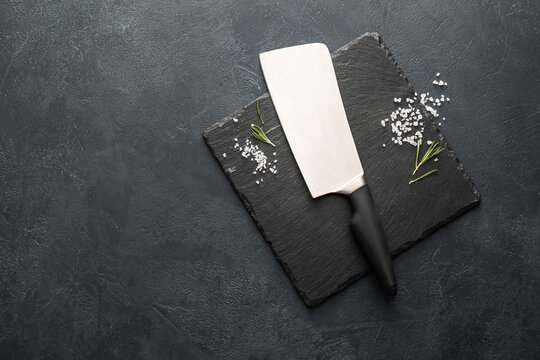 Knife with spices on dark background