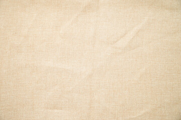 textured of beige linen fabric for background.