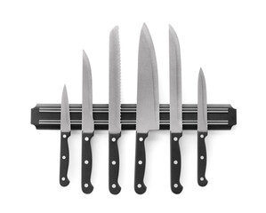 Magnetic holder with set of knives on white background