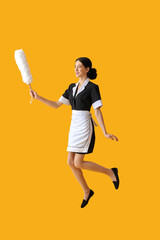 Jumping chambermaid on color background
