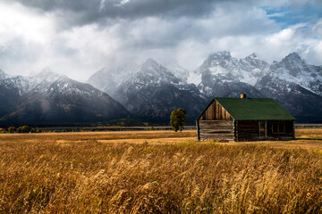 barn in Mormon Row in the  Grand tetons national park , Wyoming during a wintry weather in  autumn.