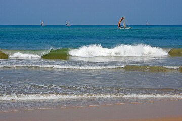 Outrigger fishing boats (oruwa) sail the aquamarine Indian Ocean off the coast of Negombo, Sri Lanka.