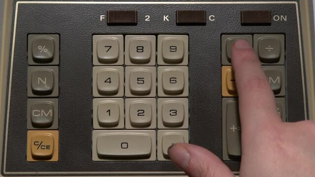 Close up of typing on a vintage calculator