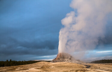 Fototapeta na wymiar dramatic photo of an erupting geyser in Yellowstone national park in wyoming.