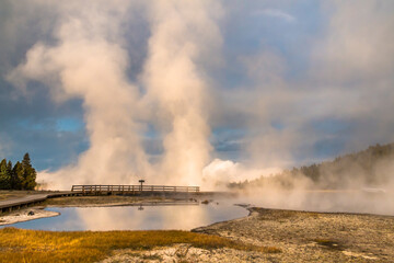 dramatic photo of bubbling and steaming hot spring in the Yellowstone National park in Wyoming.