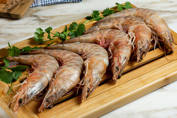 raw shrimp on wooden board or fresh shrimp on wooden board
