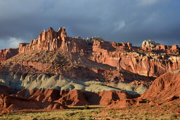 spectacular view of eroded cliffs and colorful soils along the chimney rock trail on a sunny autumn day in capitol reef national park, utah
