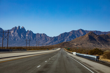 open high way in New Mexico with the Organ Mountains or Las Cruces on the background. 