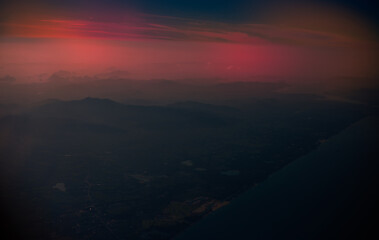 Blurred abstract background from high angle from plane window, overlooking the scenery below (river, mountain, tree).