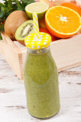Freshly blended green coctail from fruits and vegetables as healthy dessert containing vitamins and...