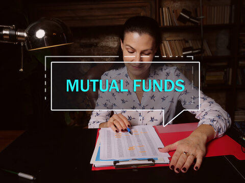  MUTUAL FUNDS Inscription On The Screen. Marketing Expert Inspecting Market Data. A mutual Fund is A Type Of Financial Vehicle Made Up Of A Pool Of Money Collected From Many Investors To Invest