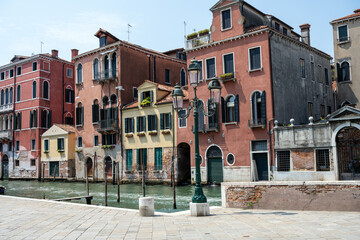 Fototapeta na wymiar Beautiful old houses and one of the famous channels seen in Venice, Italy