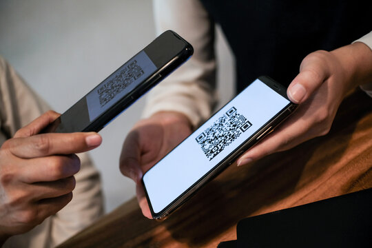 Qr code payment. Woman scanning QR code online shopping cashless technology concept.