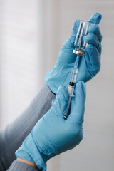 Vaccine in hands, female doctor holds syringe and bottle with covid19 vaccine for coronavirus cure....