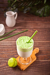 Dalgona Matcha Latte,creamy whipped matcha green tea with plant on the background
