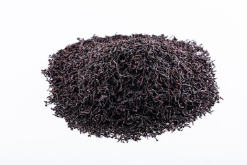 Heap of black tea on a white background. Dry black tea leaves isolated on white background, delicious, natural. Flat lay.