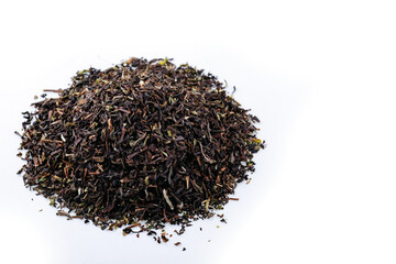 Heap of black tea on a white background. Dry black tea leaves isolated on white background, delicious, natural. Flat lay.