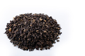 Heap of black tea on a white background. Dry black tea leaves isolated on white background, delicious, natural. Flat lay.