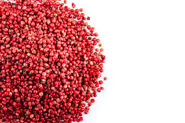 Heap of pink peppercorns on a white background. Spicy spice.Spice. Pink pepper.