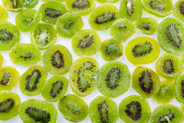 Dried Preserved Kiwi Fruit background. A dried kiwi fruit snack. A bunch of dry kiwi on a white background. Dry kiwi fruits.