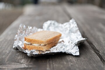 Sandwich on aluminum foil for breakfast on the outdoor trip. Breakfast in the mountains.