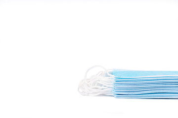 A stack of medical protective masks on white background. Backdrop with copy space.