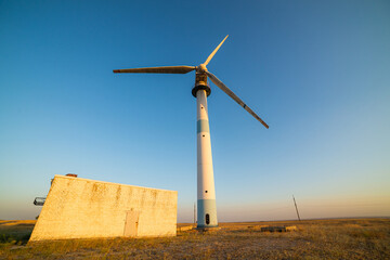 Old abandoned wind turbines in the desert landscape