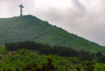 Christian cross on mountain top, rocky summit, beautiful inspirational landscape